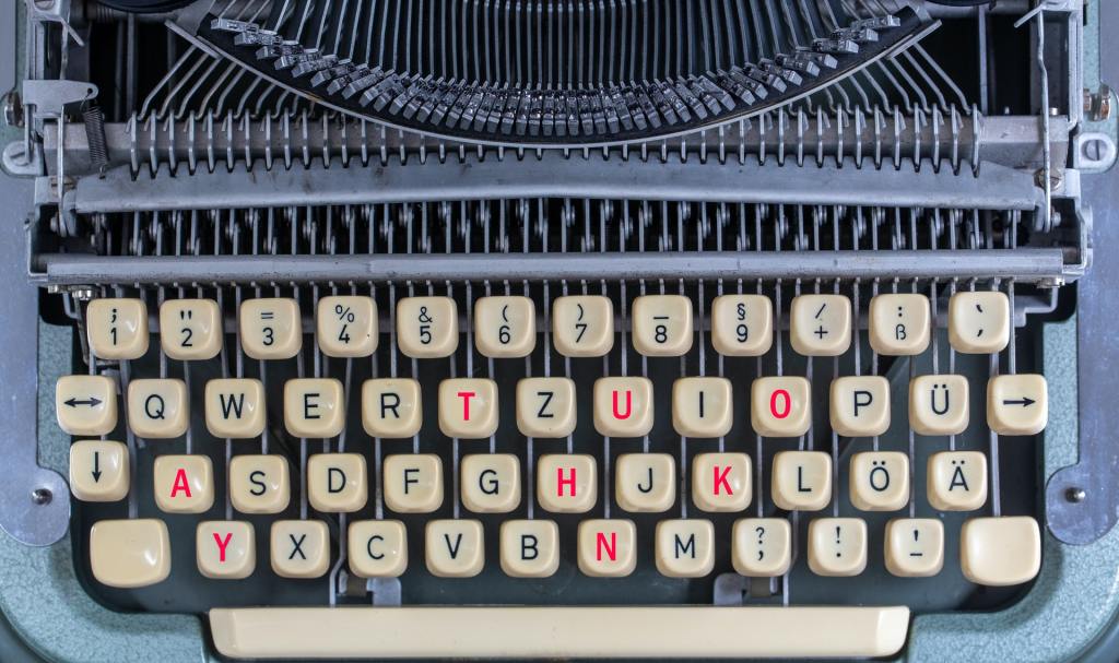 Typewriter with the letters forming "thank you" in red