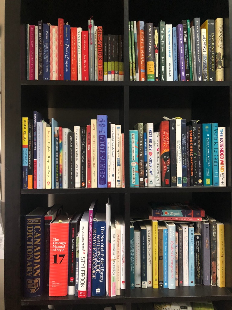 A bookshelf with three shelves of books.