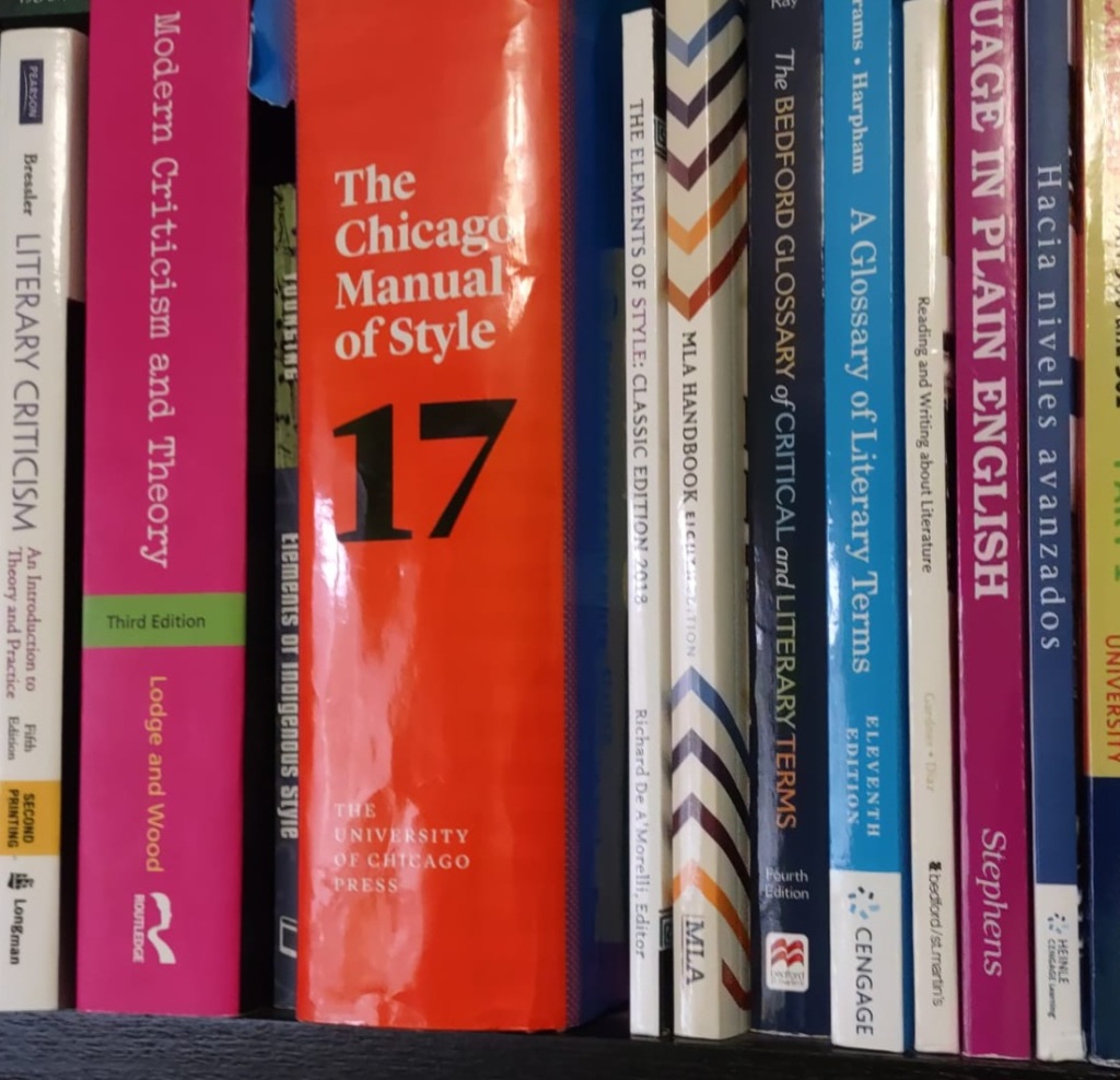 A closeup of some books on a shelf. 