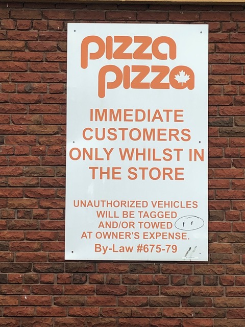 A sign reading "Immediate customers only whilst in the store" is attached to a brick wall. 